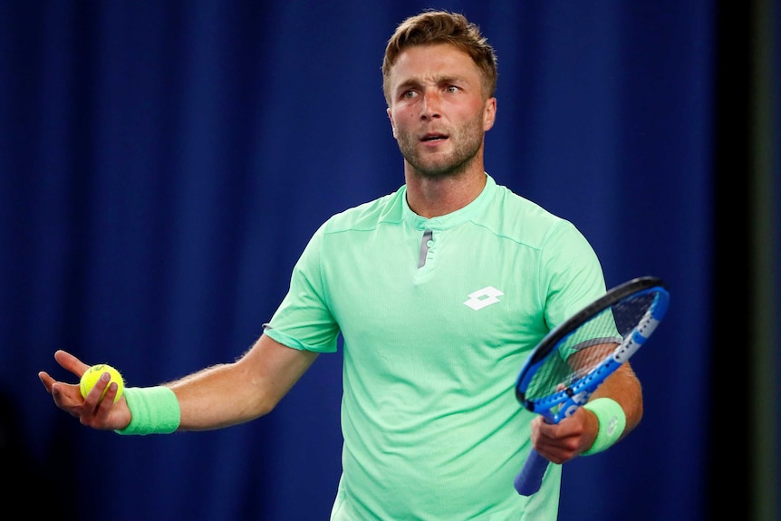 Liam Broady looks frustrated and holds his arms out.