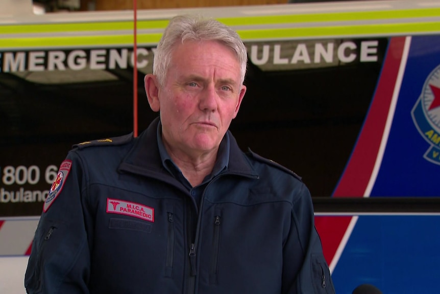 Paramedic standing in front of an ambulance