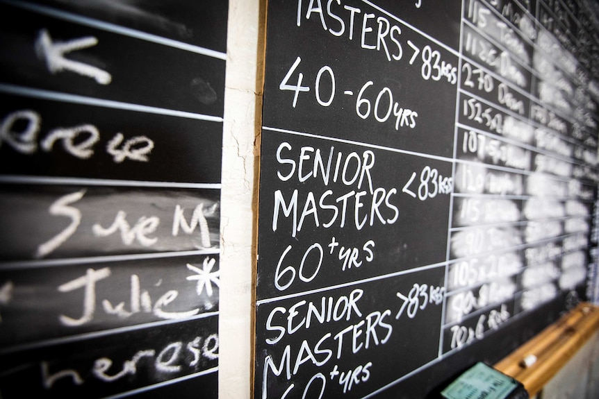 A black board with white writing advertising a competition for Senior Masters 60+ years