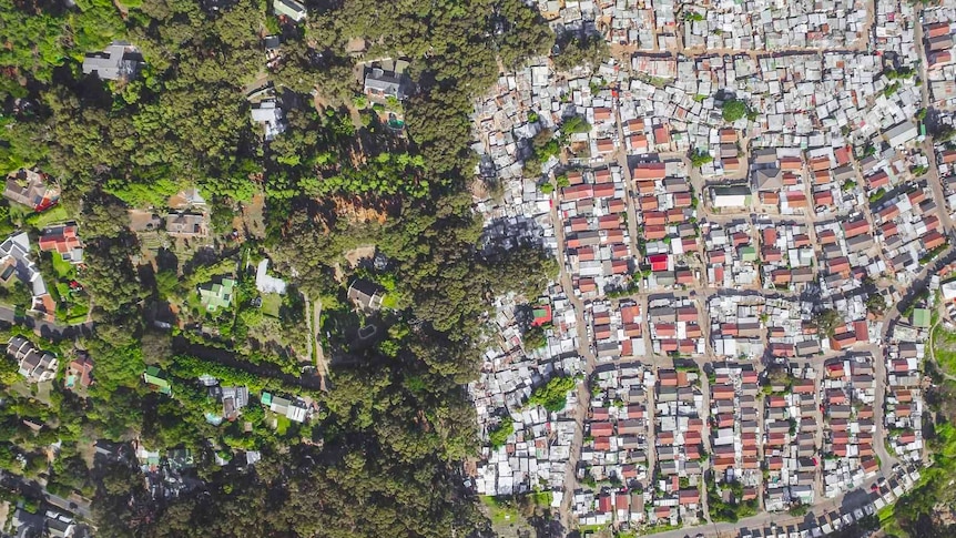 An aerial photo showing a rich neighbourhood and slums side by side