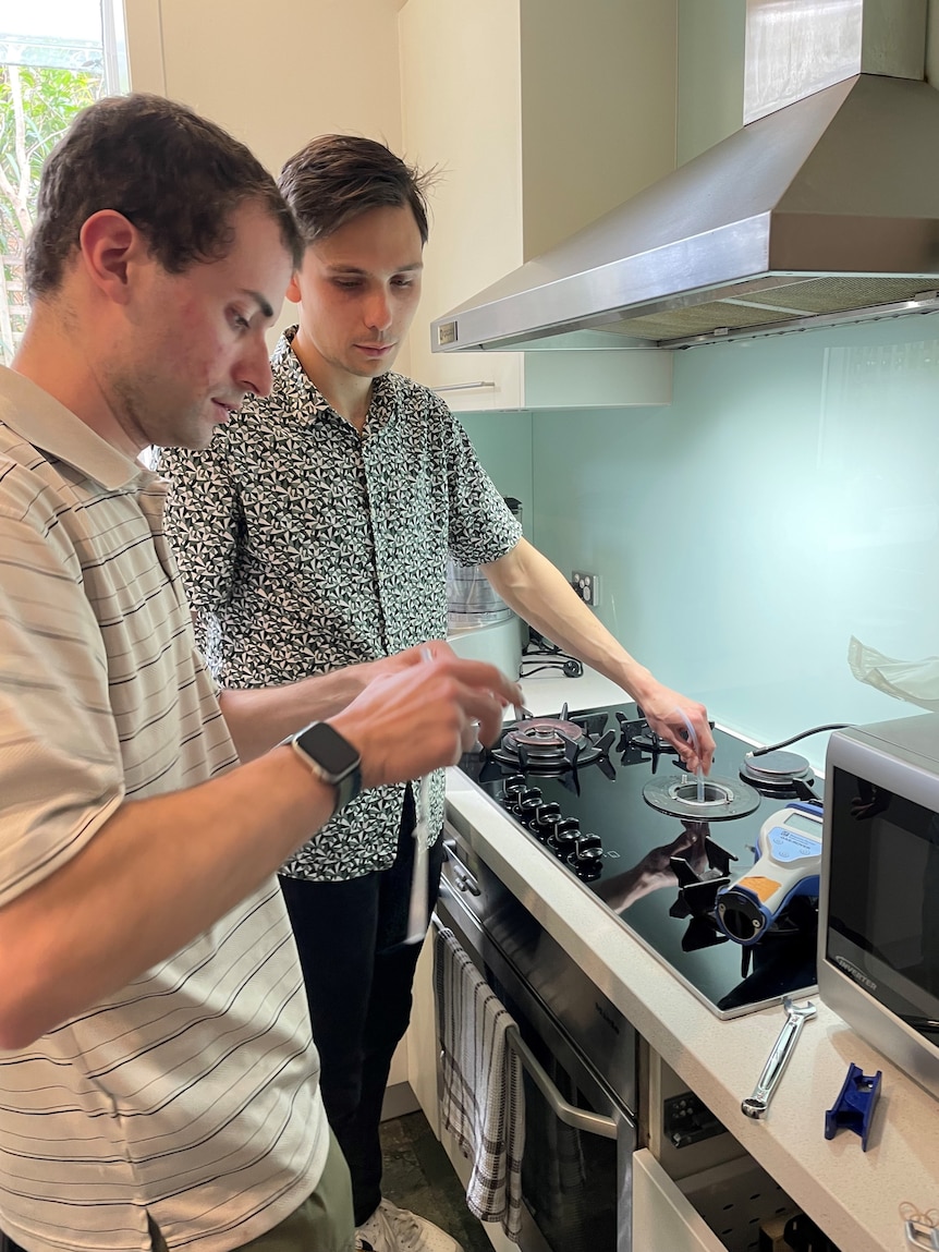 Eric Lebel taking samples of gas from a stove.