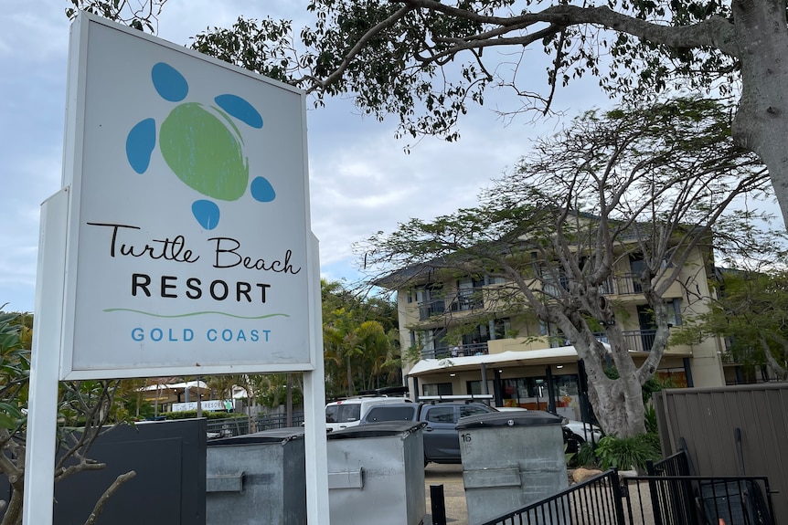 A sign outside a unit complex which reads 'Turtle Beach Resort'
