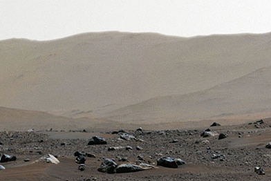 A rim of a crater is seen on Mars