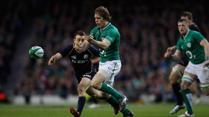 Comprehensive win ... Andrew Trimble spreads the ball for Ireland