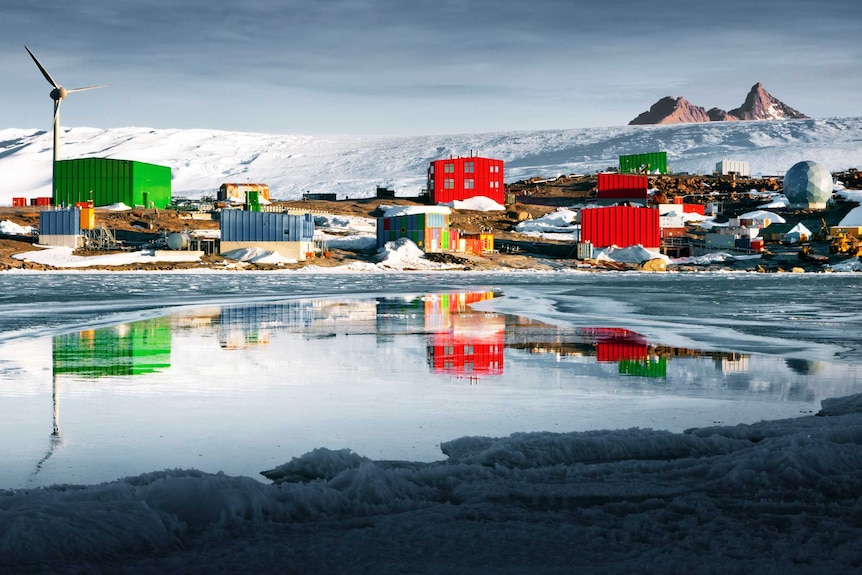 A brightly coloured research station on the Antarctic ice.