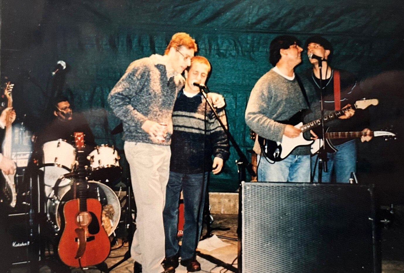 A casual band on stage at a party.