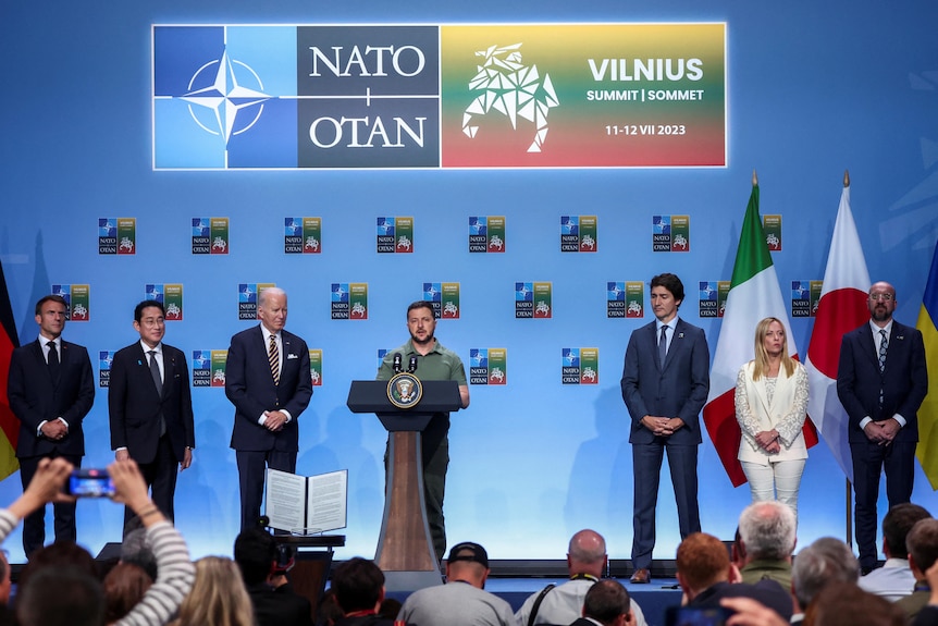 Leaders of countries standing in line at NATO summit.