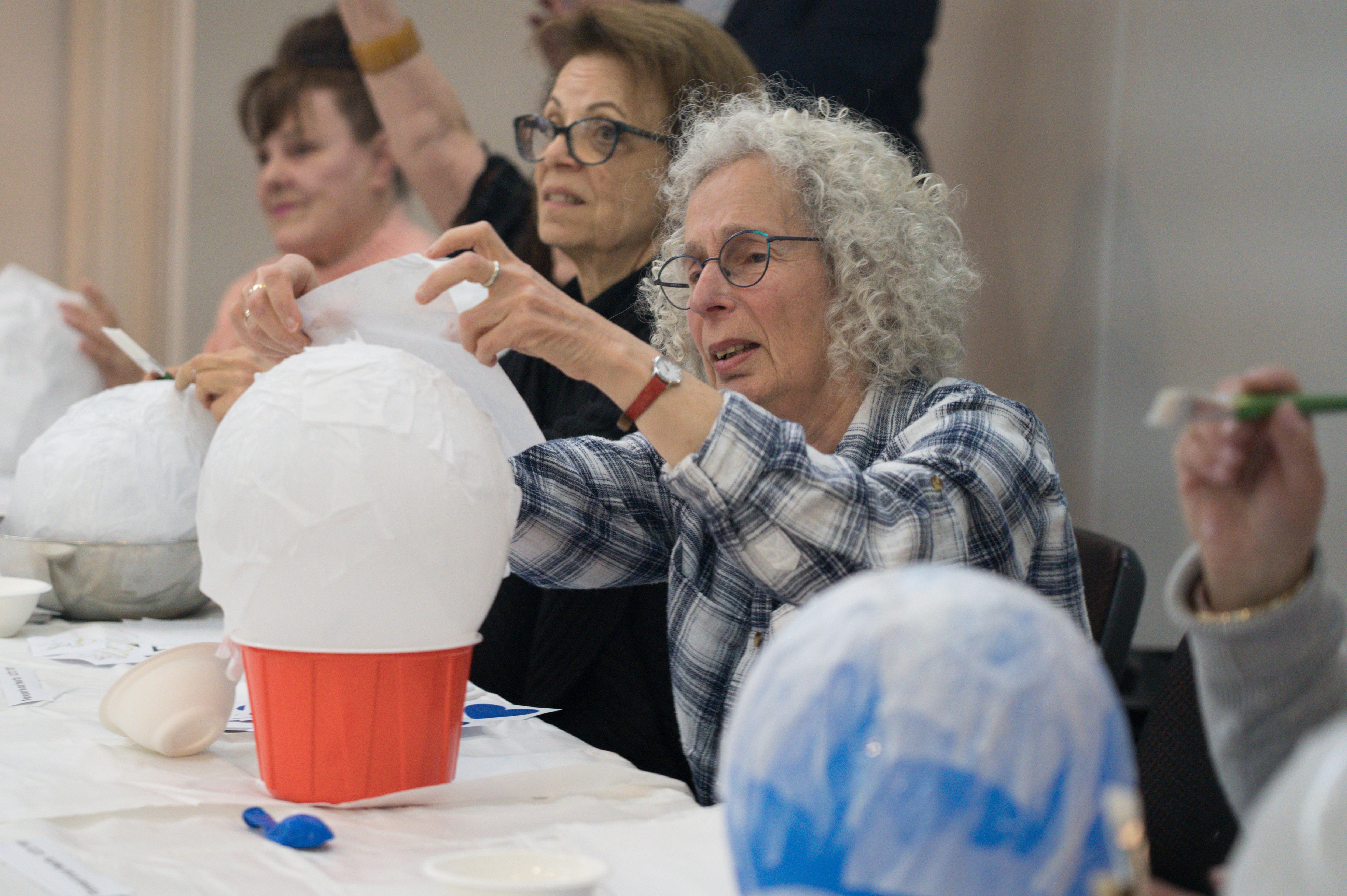 A woman making a paper mache lantern
