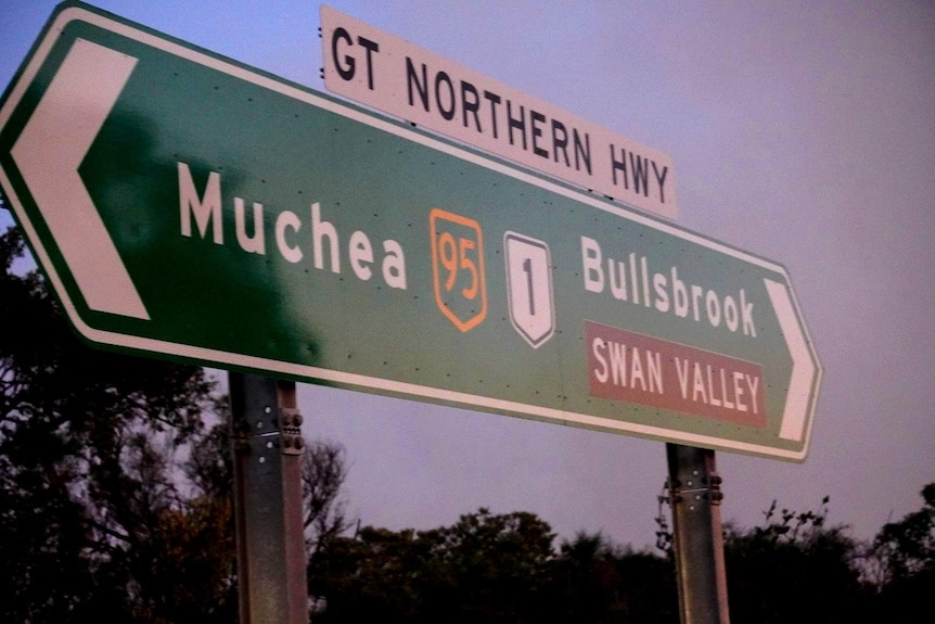 A road sign on the Great Northern Highway in WA pointing to Muchea in one direction and Bullsbrook in the other.