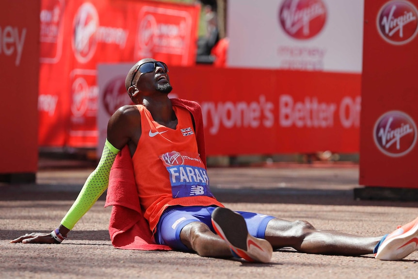 Mo Farah sits on the floor after hot London Marathon