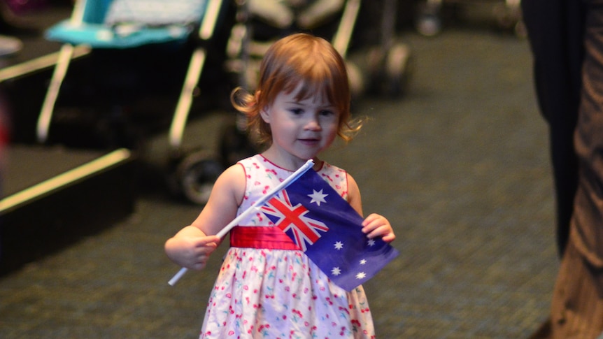 A young girl plays at a citizenship ceremony in Brisbane on Australia Day, 2012.