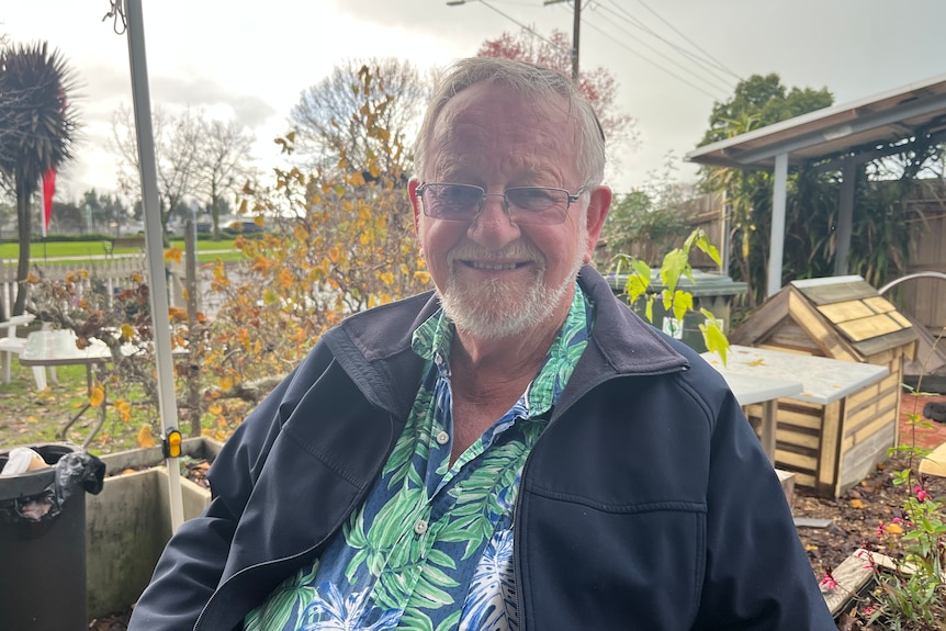 Michael Fozard sitting in the front yard of his Cafe in Yarragon 