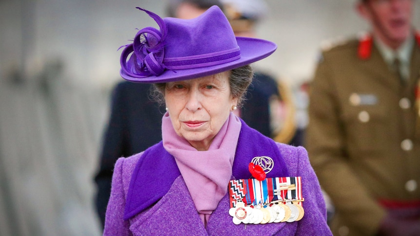 Princess Anne in a vibrant purple jacket with matching scarf and hat 