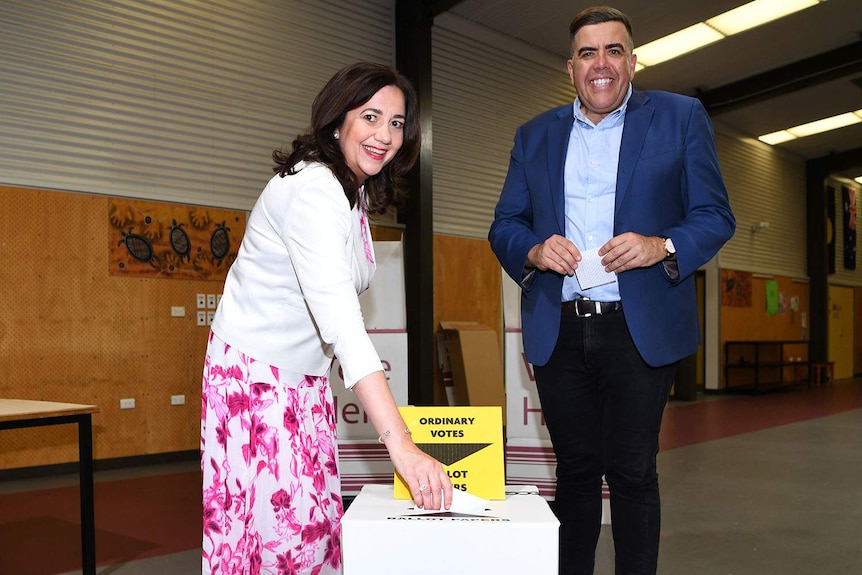Annastacia Palaszczuk, with Milton Dick alongside, votes in the state election.