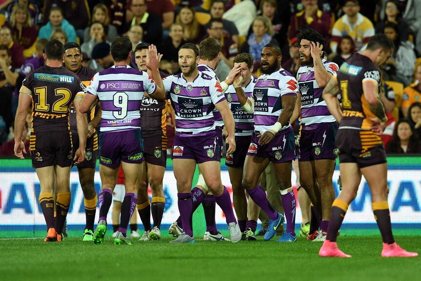 Melbourne Storm players celebrate a try against the Brisbane broncos