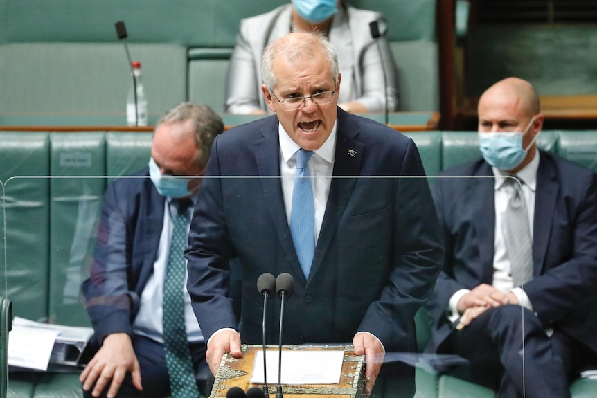 Prime Minister speaks in parliament with a piece of white paper in front of him.