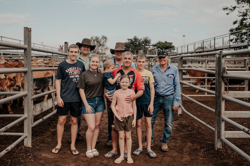 family posing in cattle yards