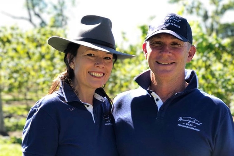 a woman and man with blue polio shirts and country hats