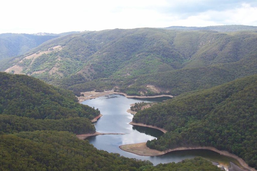 an aerial shot of a dam in Australian bushland
