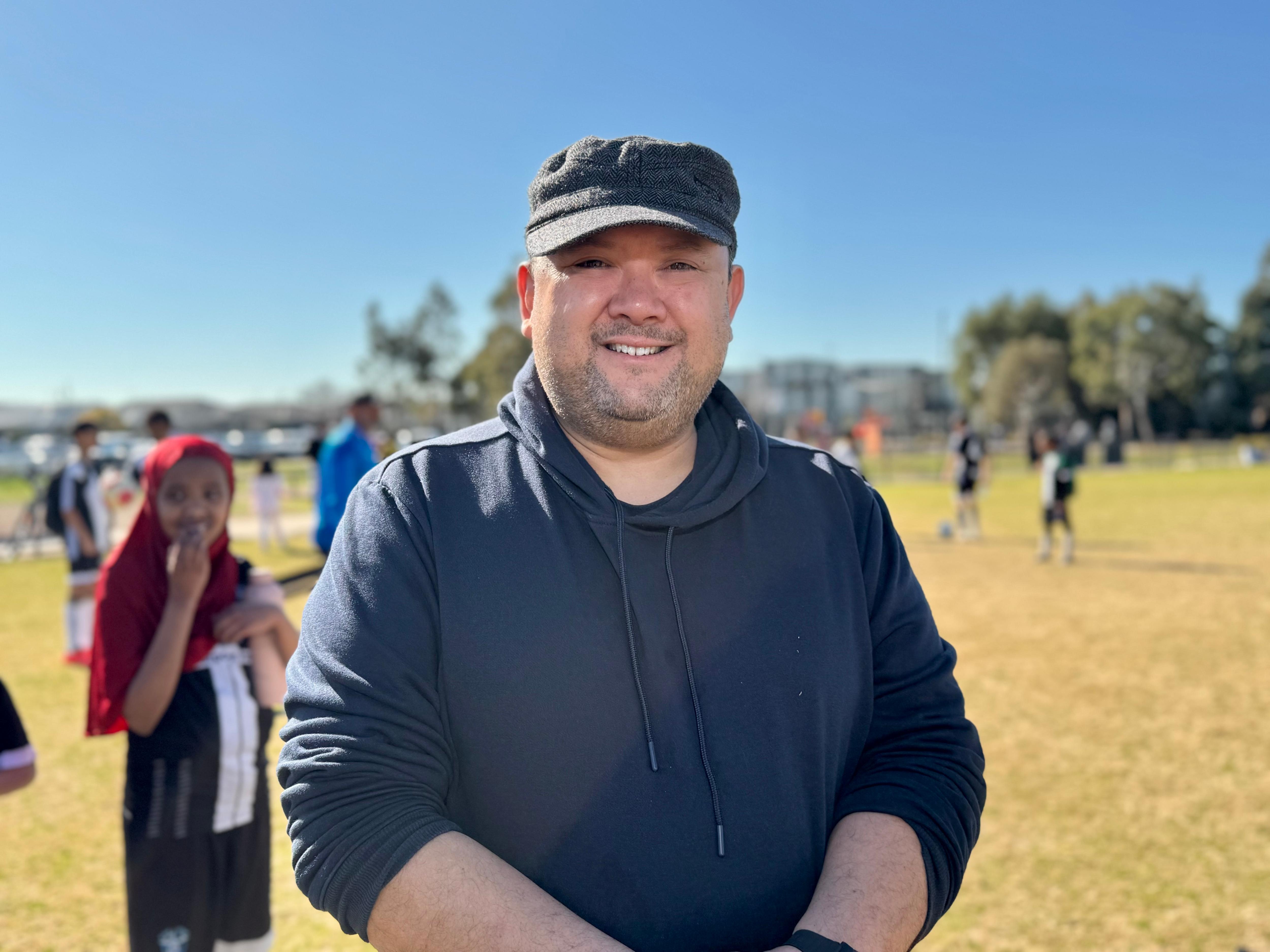 A man smiles at the camera.