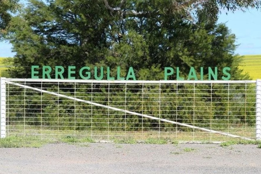 The property name Erregulla Plains sits above a farm gate with a tree and paddock in the background.