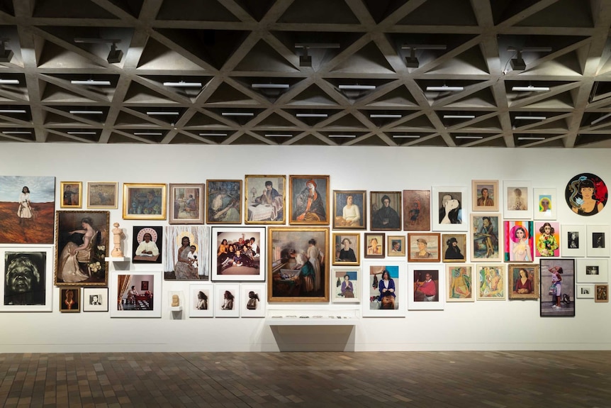 A wall in the National Gallery of Australia hung with portraits of women for their Know My Name exhibition