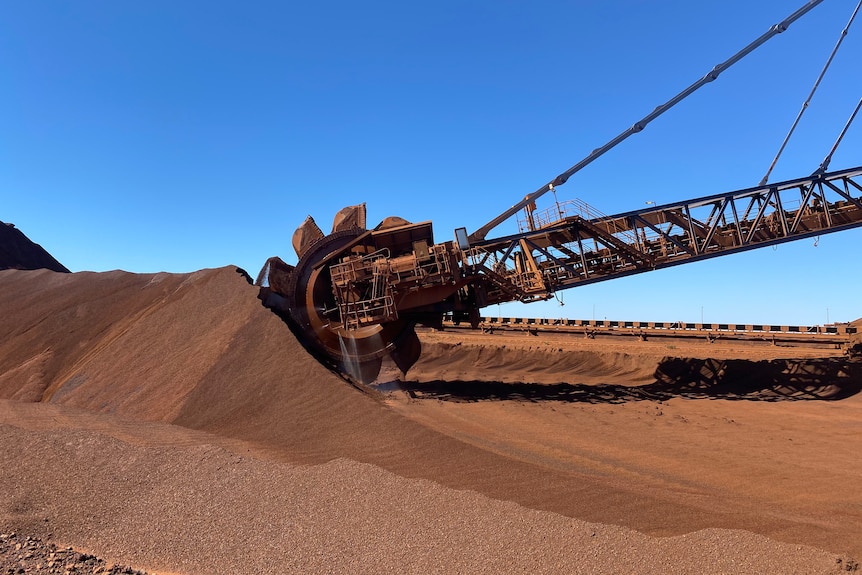 Un récupérateur des installations de Fortescue à Port Hedland récupère et mélange le minerai de fer provenant d'un grand tas.