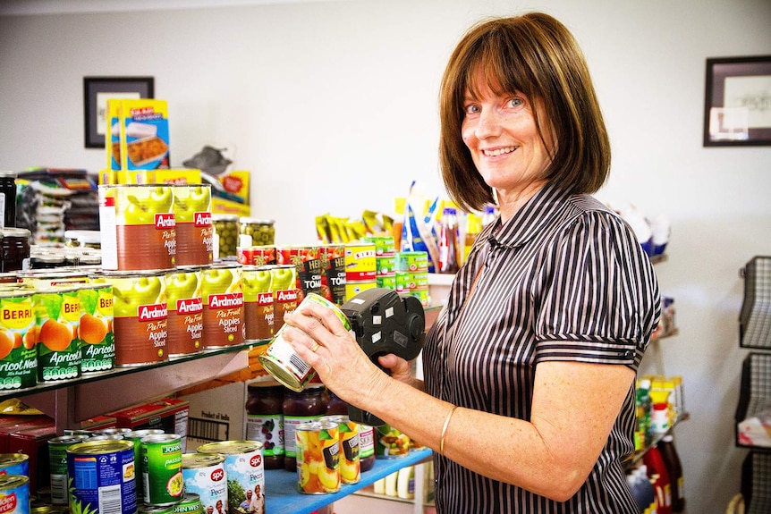'Aunty' Fiona Turnbull stocks shelves in her Muttaburra Shop and Fuel business in central-west Queensland.