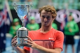 Oliver Anderson poses with the Australian Open junior boys' singles trophy in 2016.