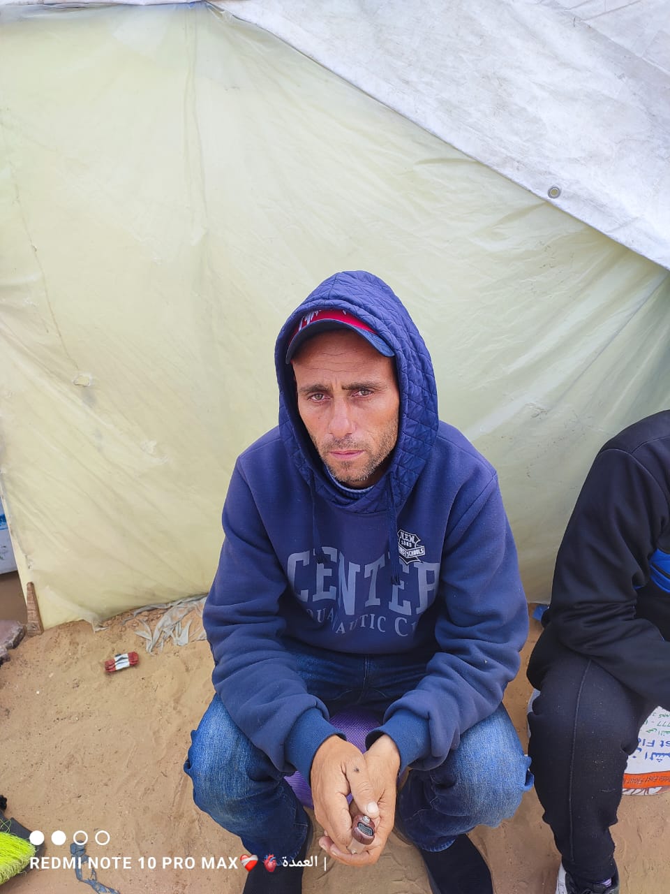 A man in a blue hoodie