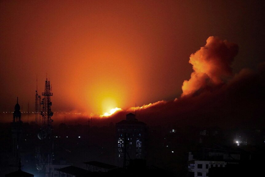 Smoke and flames rise during an Israeli nighttime air strike on west Gaza.