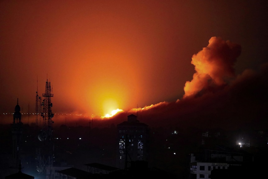 Smoke and flames rise during an Israeli nighttime air strike on west Gaza.