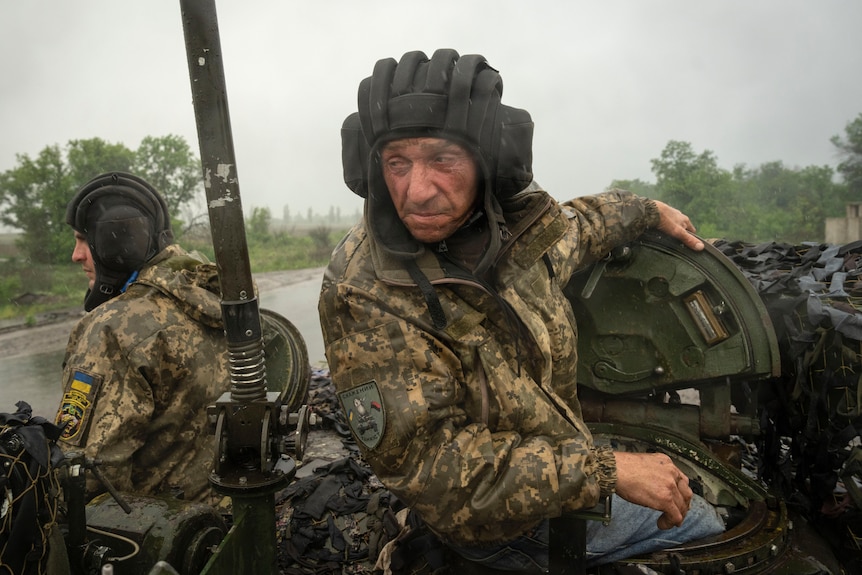 Ukrainian soldiers on a tank ride along the road towards their positions near Bakhmut.