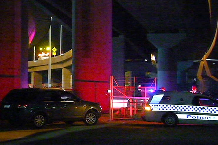 Police cars below the Bolte Bridge where a man died after crashing his motorcycle.