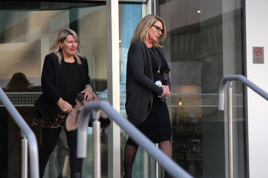 Karen Williams walks outside the WA Supreme Court with another woman behind her.