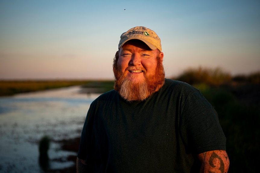 Rene Woods with the wetlands behind him at sunset.