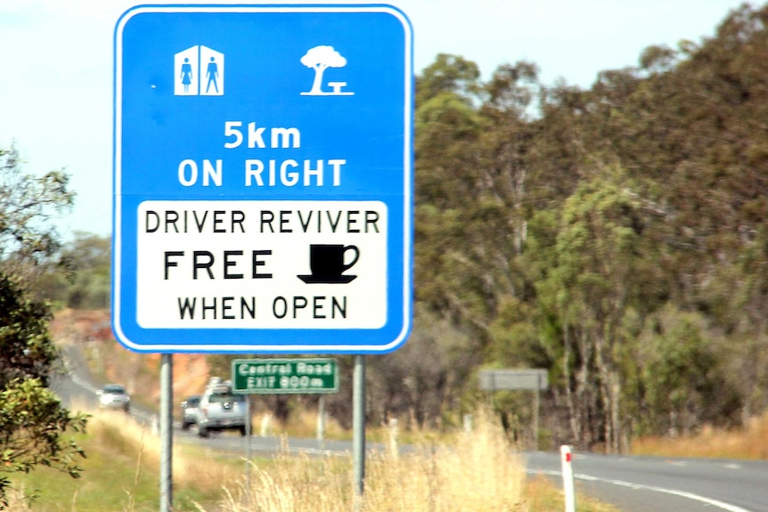 Blue driver reviver sign on the open highway