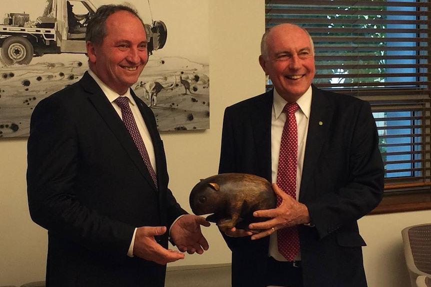 Warren Truss presents the wombat to Barnaby Joyce in 2016.