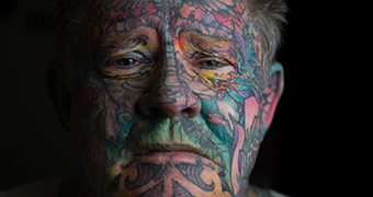 Man with tattooed face
