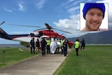 A helicopter unloads shark attack victim Glenn Dickson who is being transported to hospital in Cairns.