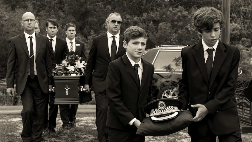 Pallbearers carry the coffin of Clement Francis Rankin