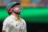 Australia batter Travis Head throws his head back as he walks off during a Test against South Africa at the Gabba.