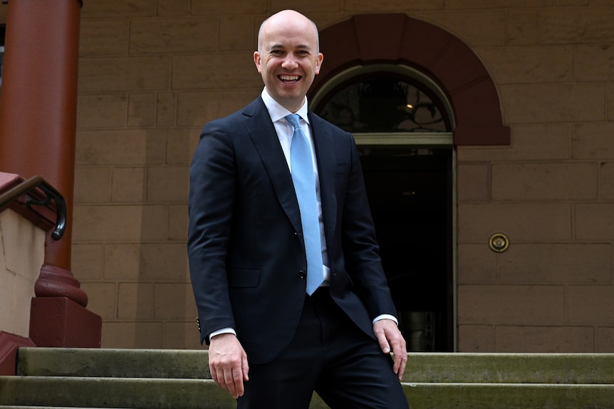 a man standing on stairs smiling