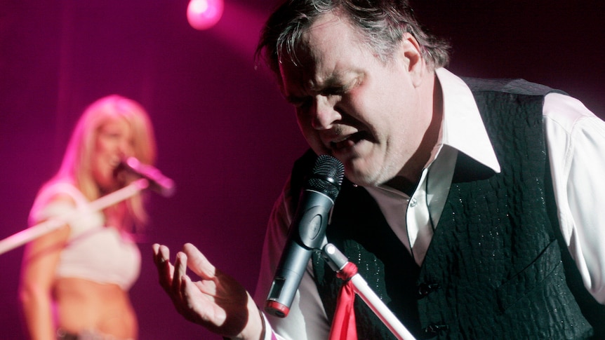 Meat Loaf singing on stage looking emotional