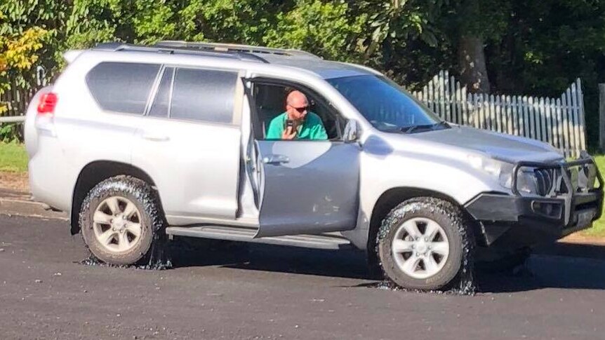 Four wheel drive with melting bitumen on wheels.