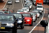 A line of cars on the road.