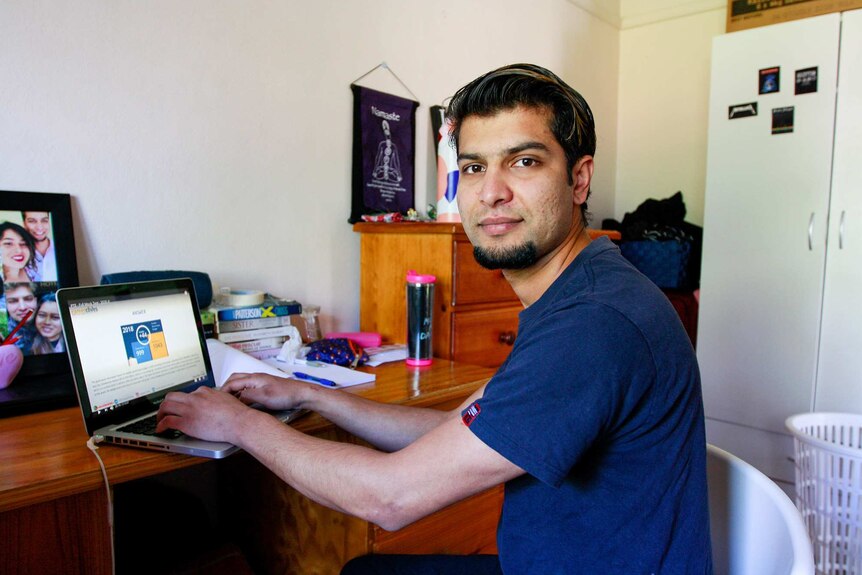 Ghana Shyam Timilsina studies at a computer in his bedroom, for a story on temporary visa workers and JobKeeper.
