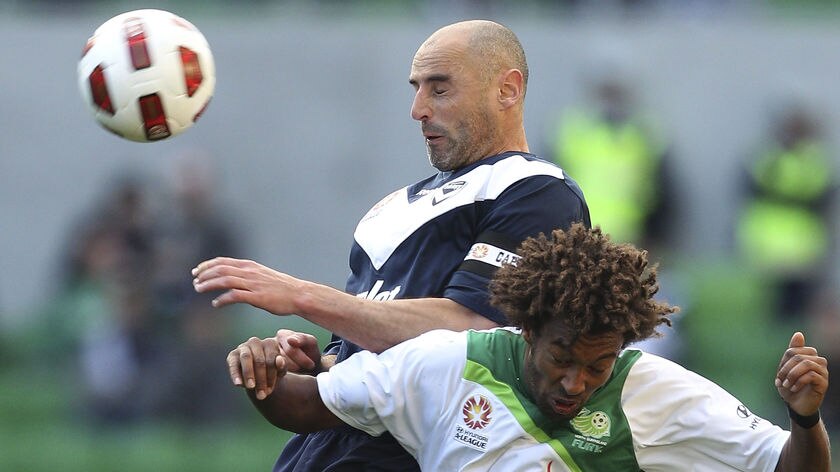 Inseparable: Dual goal-scorer Kevin Muscat battles with the Fury's Isaka Cernak.