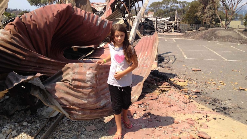 Billie Hassett walks through the bushfire-hit Dunalley Primary School