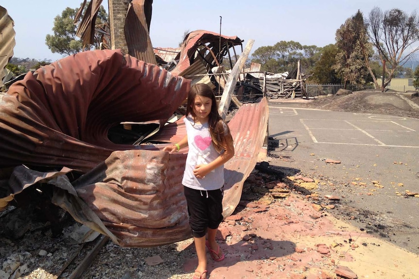 Billie Hassett walks through the bushfire-hit Dunalley Primary School